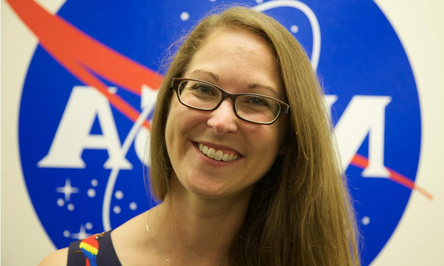 Cassie Hilditch headshot with NASA logo in the background